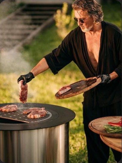 Chef carrying a steak to the WATRAG grill