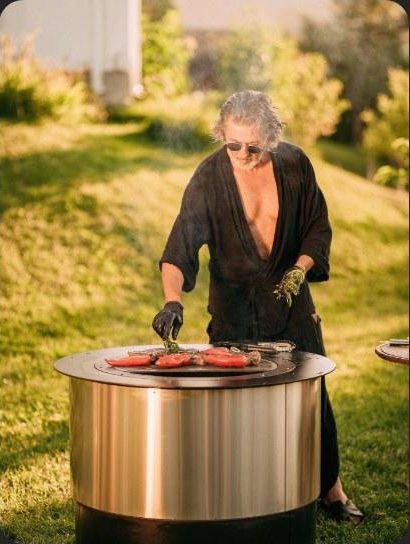 Grilling at a stainless-steel WATRAG fire pit